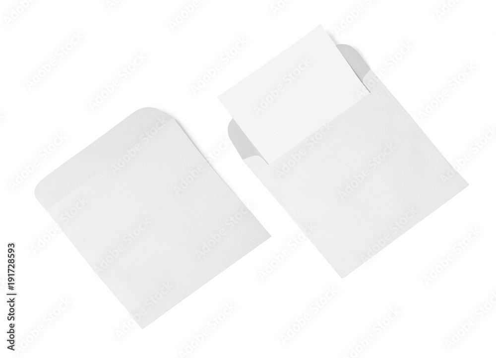 White envelope and post card on a background, top view. Blank envelope mockup and blank letterhead presentation template. White envelope and post card on a background, top view. Blank envelope mockup and blank letterhead presentation template.
