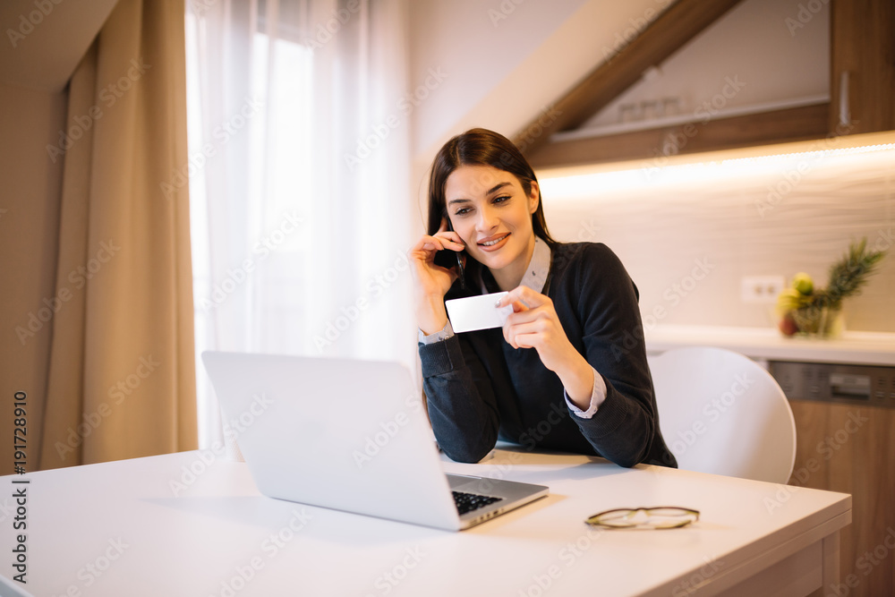 Girl shopping online, talking on mobile, using laptop. Girl shopping online, talking on mobile, using laptop.