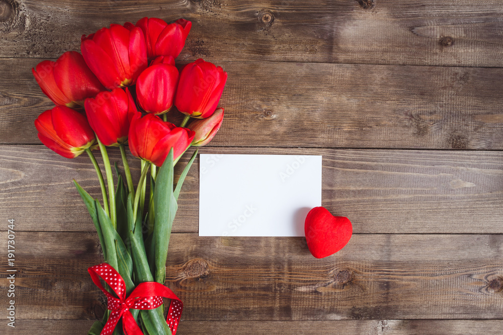 Spring flowers. Bouquet of Red tulips on brown wooden background. Spring flowers. Bouquet of Red tulips on brown wooden background.