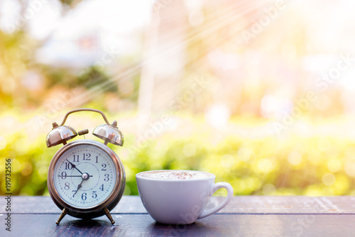 Coffee cappuccino in the morning and an alarm clock.