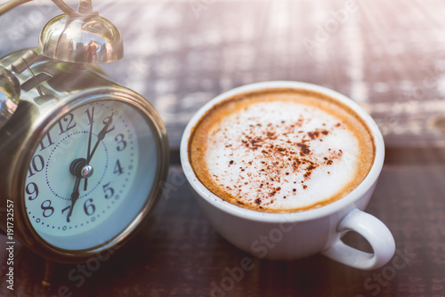 Coffee cappuccino in the morning and an alarm clock