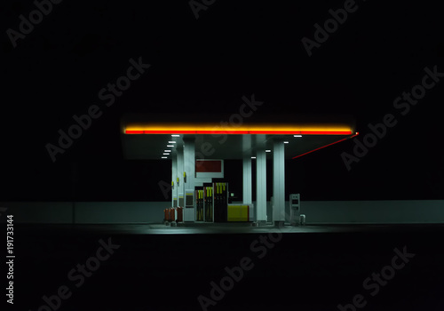 Illuminated gas station at night.