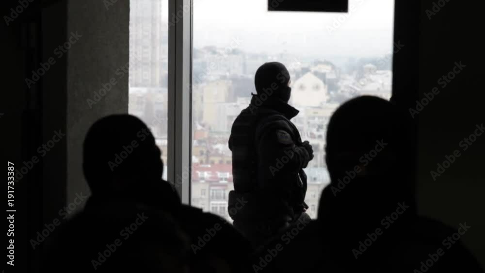 Special forces in masks blocking the entry into the office building. The police conduct a search in the office