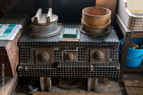 A old retro stove in the kitchen in a country house. A old retro stove in the kitchen in a country house. photo