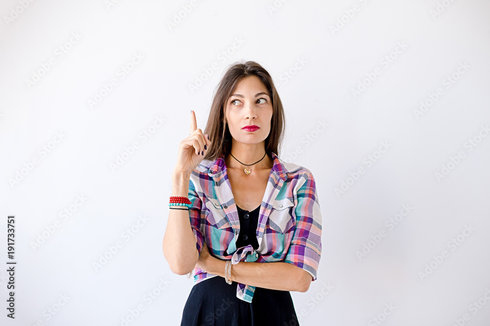 Hipster girl have an idea pointing a finger up Hipster girl have an idea pointing a finger up