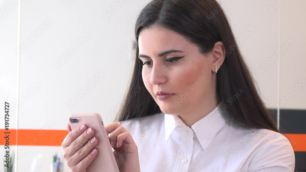 Close up successful young business woman job inside office checking mobile phone Close up successful young business woman job inside office checking mobile phone