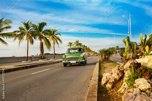 Old green American car on the Cienfuegos Malecon photo
