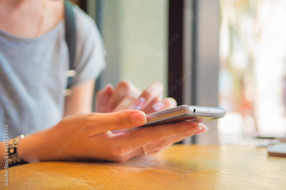 A girl is sitting with a phone in a cafe, a coffee house A girl is sitting with a phone in a cafe, a coffee house