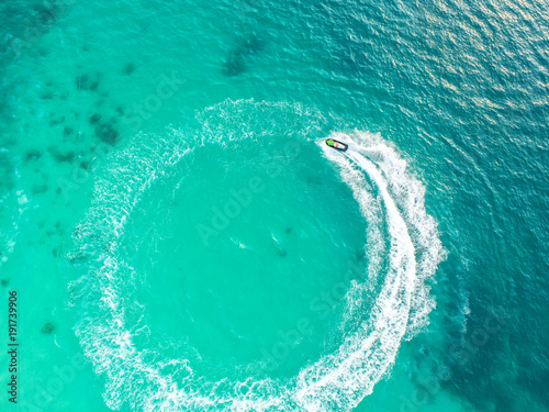 People are playing a jet ski in the sea.Aerial view. Top view.amazing nature background.The color of the water and beautifully bright. Fresh freedom. Adventure day.clear turquoise at tropical beach
