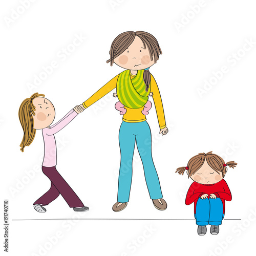 Naughty jealous little girl fighting mother's attention, tugging her hand, behaving bad. Her sister little girl, sitting on the ground being sad. Mum carrying third child, little baby, in baby sling.