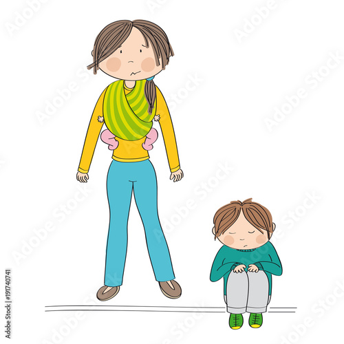 Sibling rivalry. Sad little boy sitting on the ground being sad. His mother standing behind him carrying his sister, little baby girl, in baby sling. Mum doesn't know what to do.