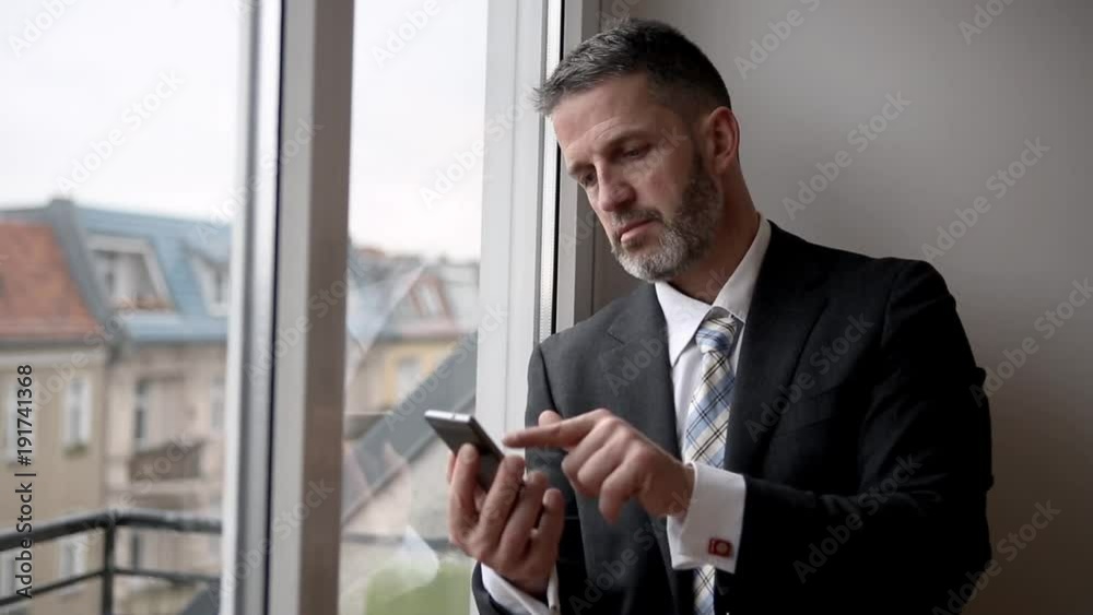 Cinemagraph of businessman standing by window and writing on his phone
Cinemagraph of businessman standing by window and writing on his phone