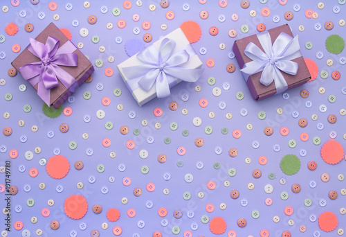 Decorative background with colored buttons in bulk and gift box.