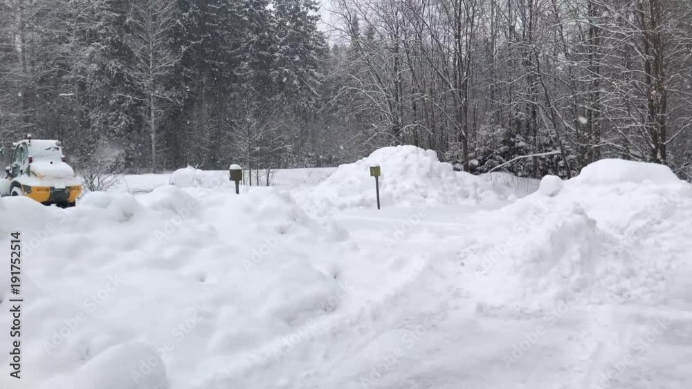 Cold winter day with snowfall. Tractor left under snow. Cold winter day with snowfall. Tractor left under snow.