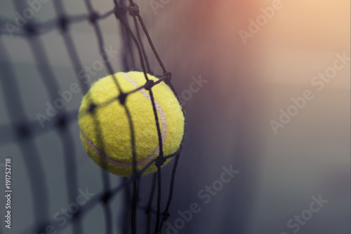 Tennis ball hitting the tennis net at tennis court with copy space.