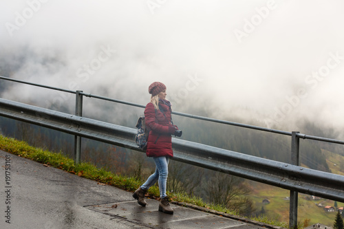 girl on a rural road in switzerland in the fog