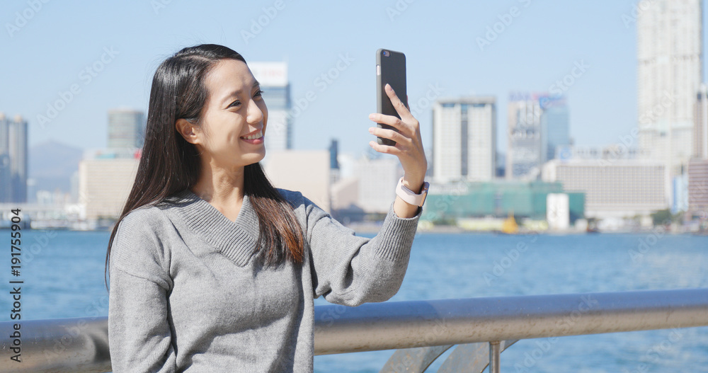 Woman making video call on cellphone in Hong Kong