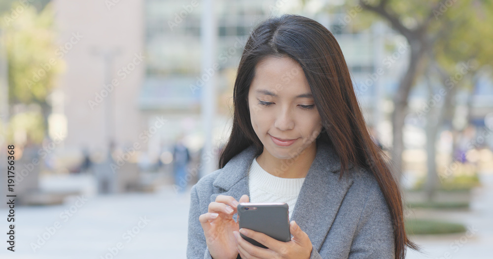 Business woman sending audio message on cellphone Business woman sending audio message on cellphone
