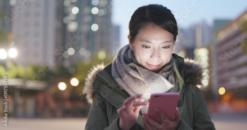 Photography Woman use of mobile phone in city at night
