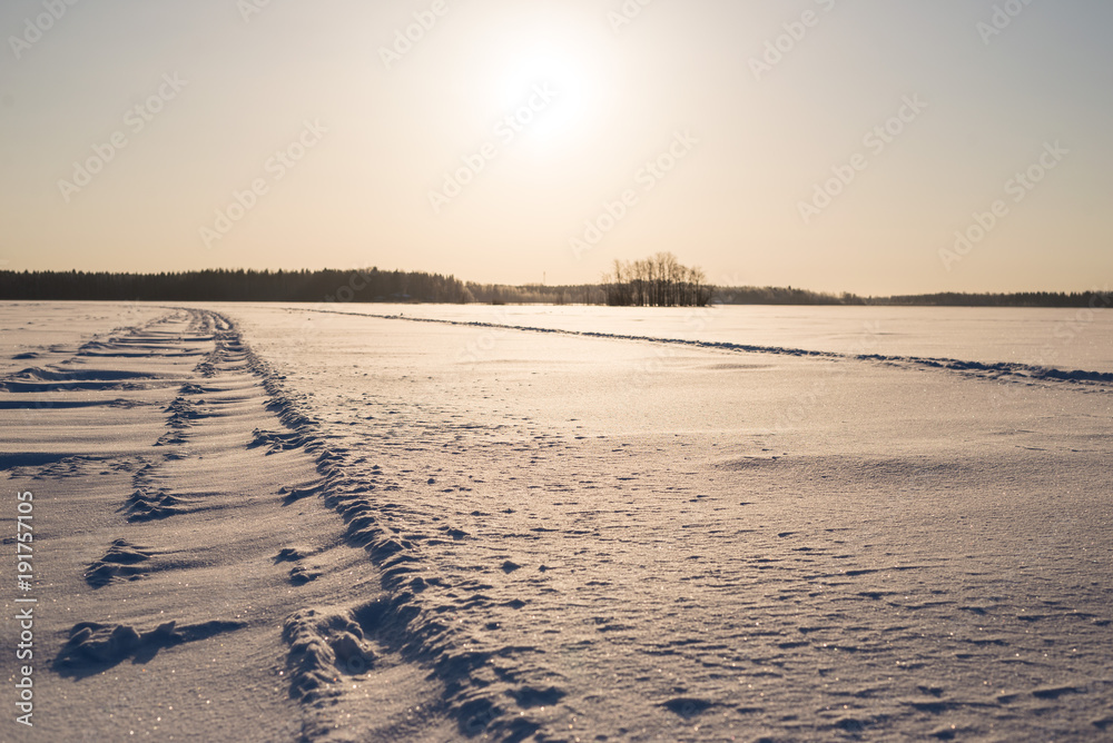 Sunny Day on Snowy Lake Ice, focus on foreground