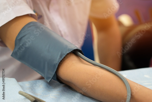 Health and Medical concept. Man checking health blood pressure and heart rate with pressure gauge digital in hostpital. Blood pressure (BP) is pressure of circulating blood on walls of blood vessels.