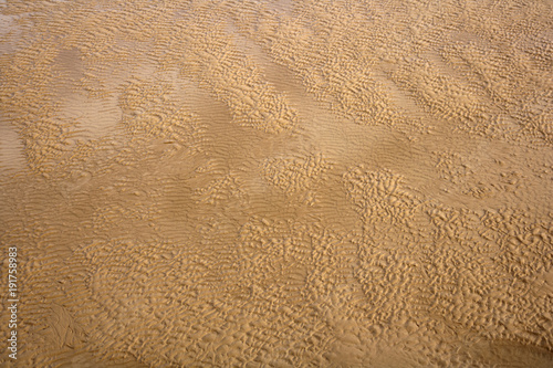 Ripples in the sand and seawater texture