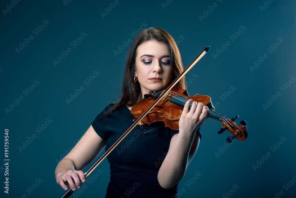 Woman with violin on blue grey background Woman with violin on blue grey background