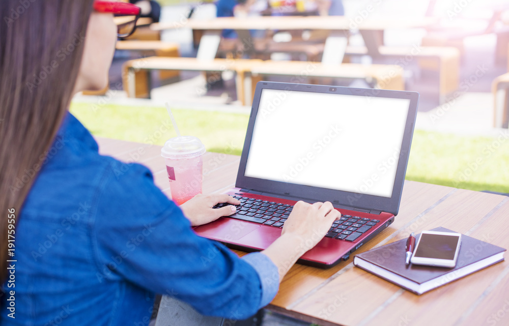 Woman in glasses working on laptop outdoors. Back view Woman in glasses working on laptop outdoors. Back view