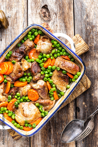 Meat baked with carrot and green peas