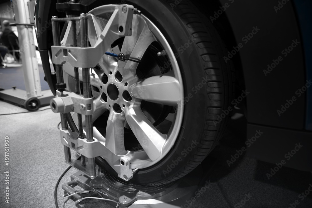 Tyre balancing of modern car in workshop Tyre balancing of modern car in workshop