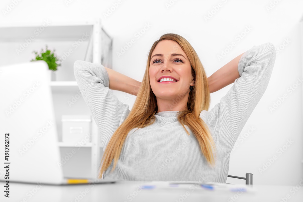 Attractive blonde in the office at the desk relaxes. Attractive blonde in the office at the desk relaxes.