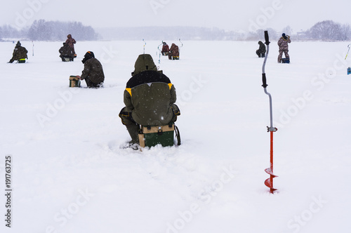 Fisherman ice fishing on the river.