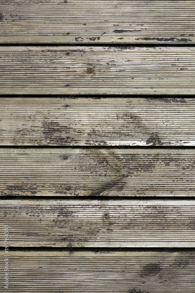 Distressed old decking boards in need of treatment Distressed old decking boards in need of treatment