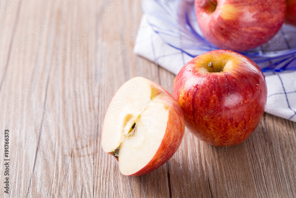 Fresh red apple and slice on a wooden table. Fresh red apple and slice on a wooden table.