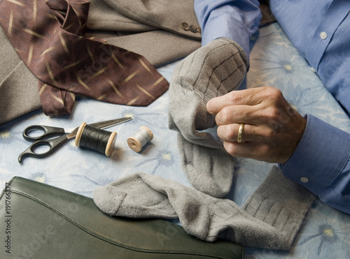 business man darning socks