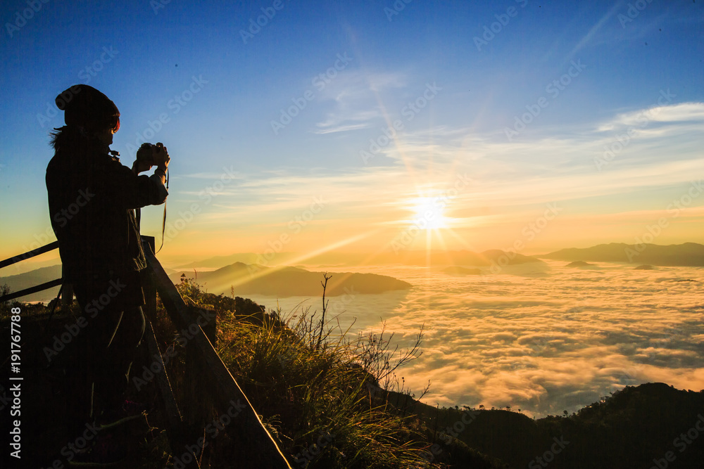 women Travel  nature in the mountains,Woman watching the sunset.