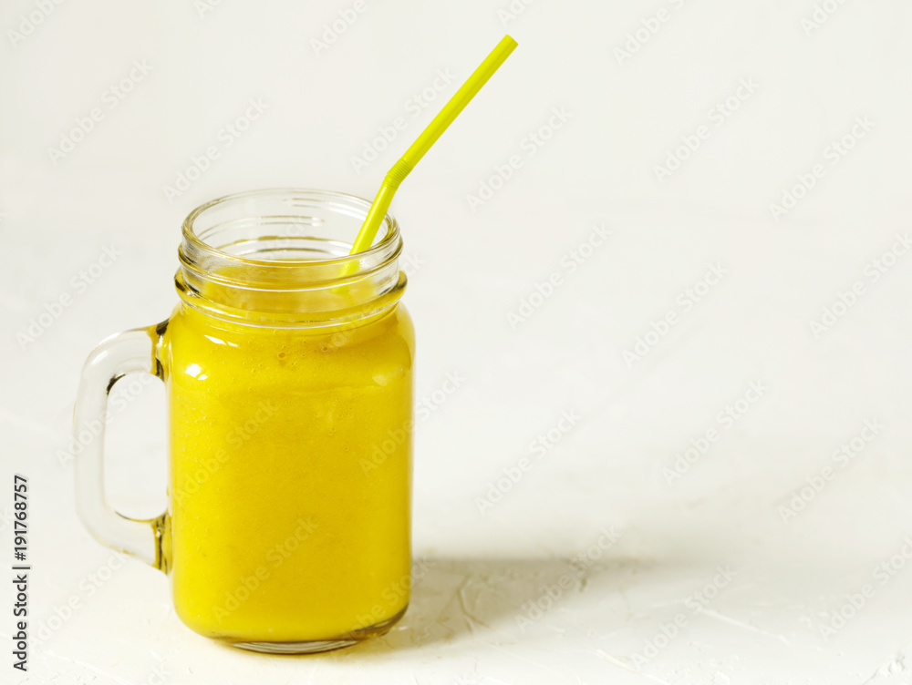 Banana Mango Smoothie in mason jar. Healthy vegan eating. Banana Mango Smoothie in mason jar. Healthy vegan eating.