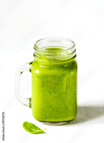 Green Spinach, Apple and Avocado Smoothie in mason jars. Healthy vegan eating.