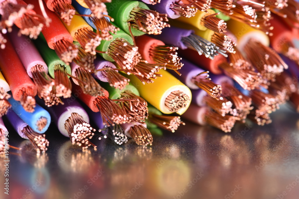 Colored copper electic cables closeup on metal surface with reflexion Colored copper electic cables closeup on metal surface with reflexion