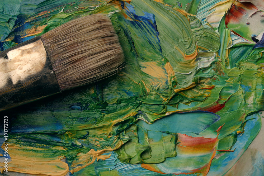 Fototapeta premium Close up of artists palette, oil paints and brush