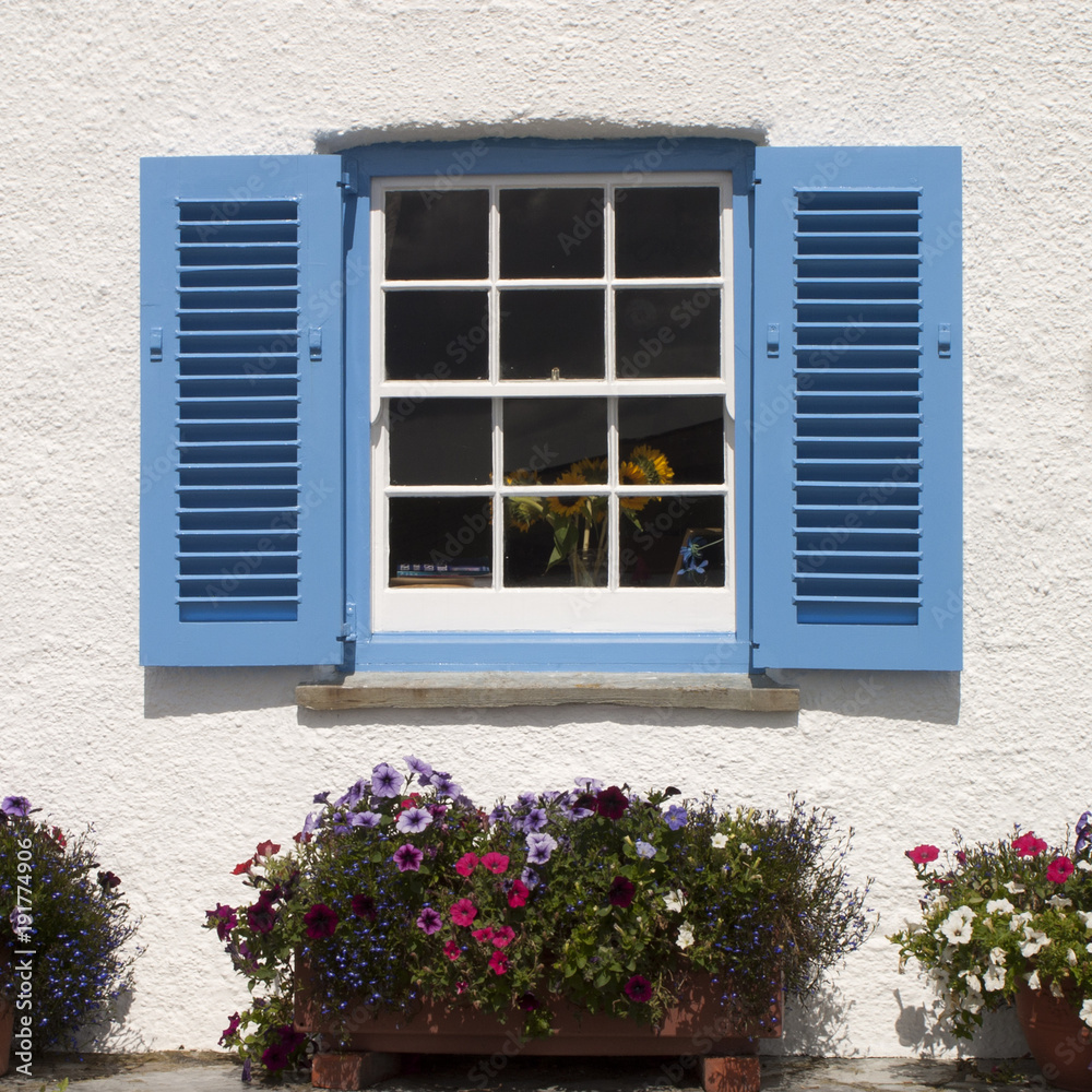 Colourful shuttered window on a seaside house