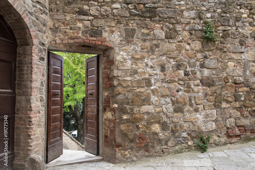 Open door on ancient brick wall © David
