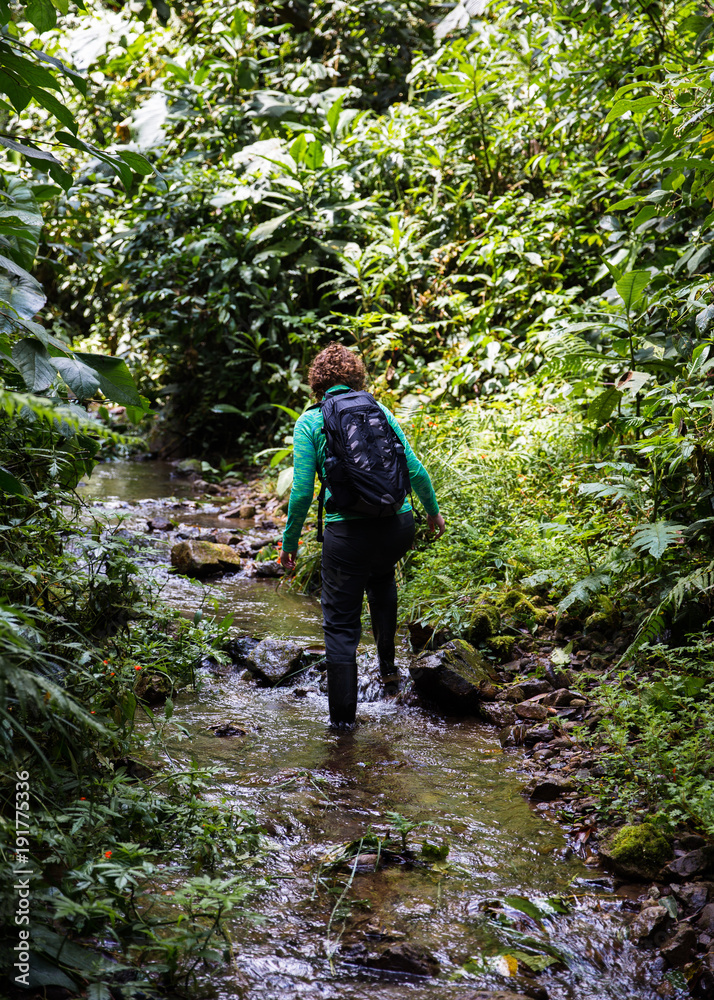 Hiking woman in stream