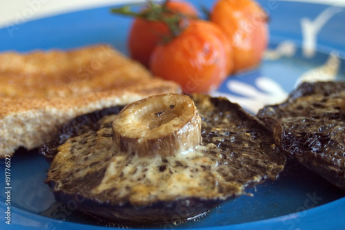 Simple healthy meal, grilled mushrooms with cheese, tomatoes and toast