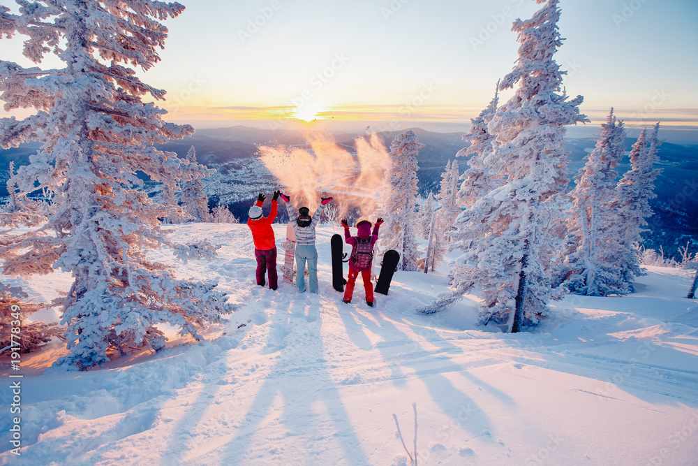 Happy team of snowboarders having fun tossing snow and fun. Concept ...