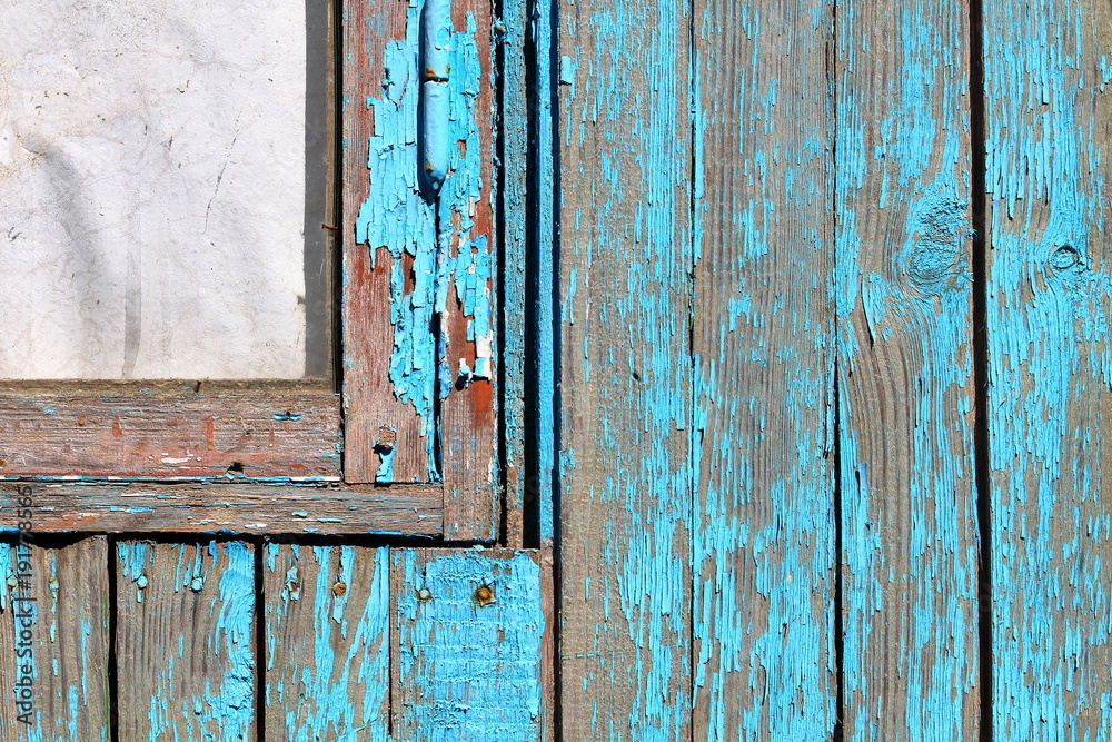 Fragment of vintage rustic grunge wooden window on blue wooden wall