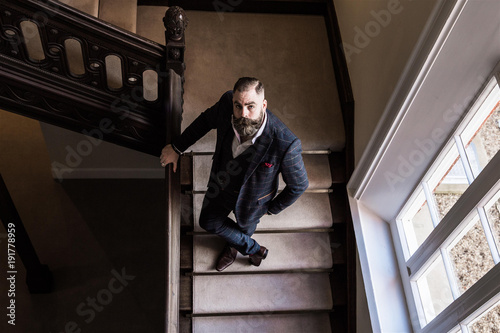 Smart man with a beard and moustache wearing a suit