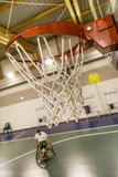 disabled sport men in action while playing indoor basketball