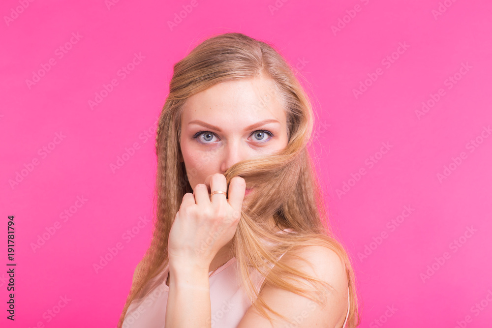 Fashion blonde over pink background. Woman portrait.