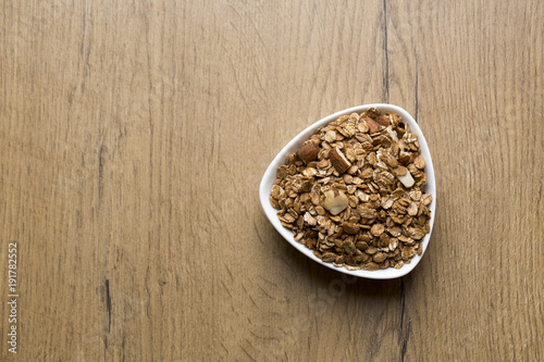 bowl of healthy granola on wooden background